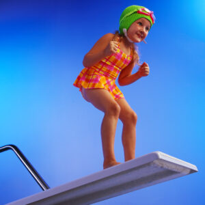 ca. 2001 --- Girl Preparing to Pool Dive --- Image by © Royalty-Free/Corbis